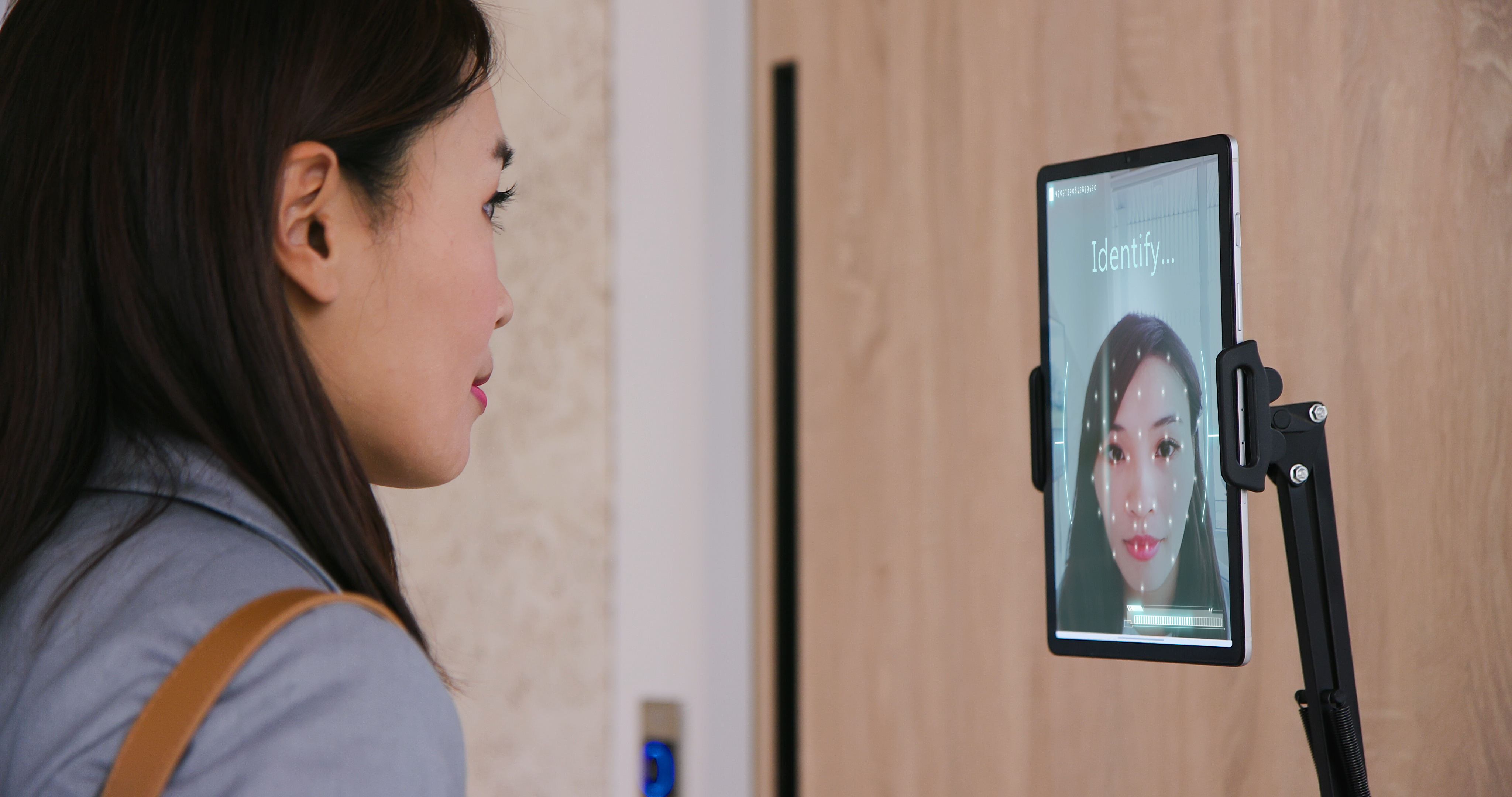 Asian woman using biometric technology